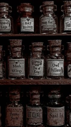 many jars with labels on them sitting on shelves