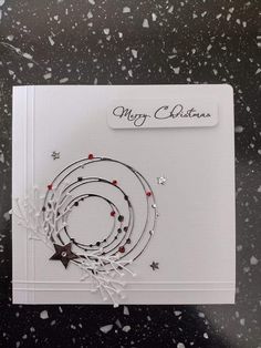 a christmas card with an ornament and stars on it, surrounded by snow