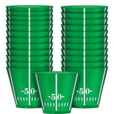 green plastic cups are stacked on top of each other