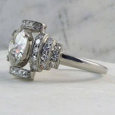 a close up view of a diamond ring on a marble surface