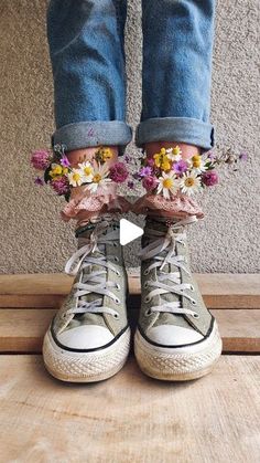 someone is wearing sneakers with flowers on the bottom and one shoe has their feet in the air