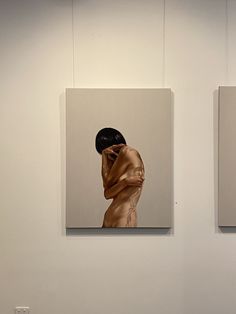 three paintings hang on the wall next to each other in a room with white walls