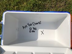 an empty ice chest with writing on the lid that says are you drunk? o yes no