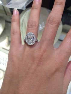 a woman's hand with a diamond ring on it