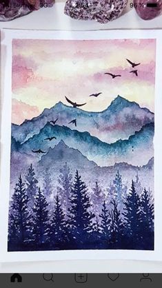 a watercolor painting with birds flying over mountains and trees in the distance, surrounded by crystals