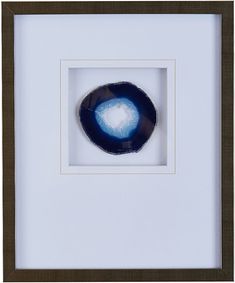 a blue eyeball in a white frame with brown trim around the edges and bottom