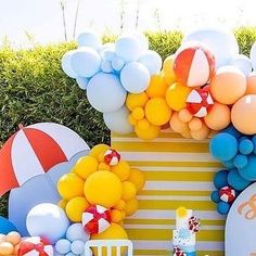 an outdoor birthday party with balloons and cake