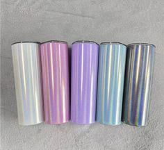 four different colors of metallic flasks lined up in a row