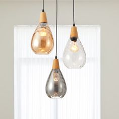 three light bulbs hanging from a ceiling