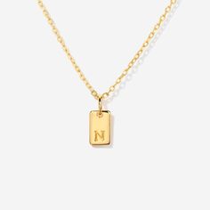 Embrace timeless elegance with this chic initial tag charm, a versatile piece designed to add a personal touch to any ensemble. Featuring a sleek, rectangular silhouette with a subtly embossed initial, this charm crafted from lustrous material is perfect for personalizing your favorite chain, bracelet, or accessory. Ideal for layering or as a standalone statement, this charm is a stylish way to keep a special initial close to your heart. Charm size: 10 mm x 5 mm Made of 14K gold over sterling si Minimalist Engraved Initial Necklace With Rectangular Pendant, Classic Personalized Initial Necklace With Rectangular Pendant, Personalized Classic Initial Necklace With Rectangular Pendant, Everyday Elegant Nameplate Charm Necklaces, Elegant Everyday Nameplate Charm Necklaces, Minimalist Personalized Initial Necklace With Rectangular Pendant, Personalized Rectangular Initial Necklace Minimalist Style, Minimalist Initial Necklace With Rectangular Pendant, Dainty Personalized Rectangular Charm Necklace