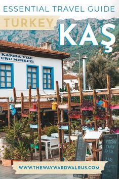 a white building with blue shutters and the words, essential travel guide kas