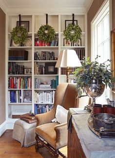 a living room filled with lots of books and furniture