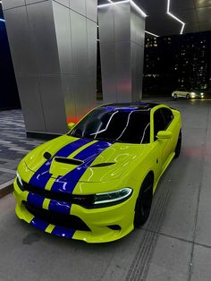 a yellow and blue car parked in front of a building