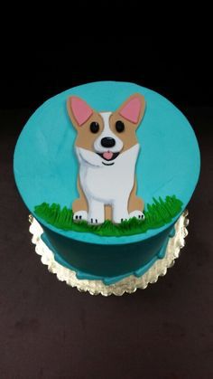 a cake with a dog on it sitting in the grass