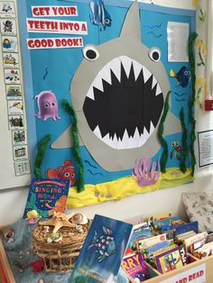 a bulletin board with a shark on it and other books in front of the wall