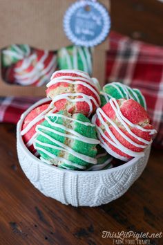 christmas cookies in a white bowl on a wooden table next to a cardboard box and plaid napkin