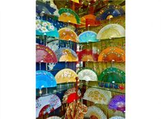 there are many colorful umbrellas on display in the store