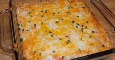 a casserole dish with cheese and green onions