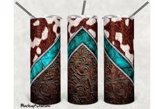 two tumbles are decorated with cowhide, turquoise and brown paint on the sides