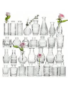 many vases and flowers are arranged on a white background with one pink flower in the middle