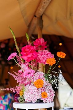 a white table topped with pink and orange flowers