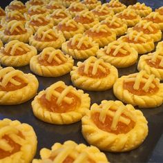 many small pastries are lined up on a baking sheet and ready to be baked