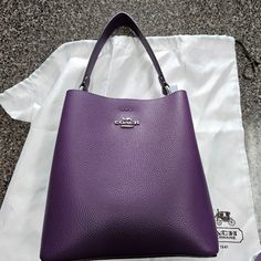 Never Used. Dust Bag And Strap Included. Elegant Bucket Bag With Silver-tone Hardware And Top Handle, Luxury Coach Bucket Satchel, Luxury Coach Bags With Removable Pouch, Luxury Coach Bag With Removable Pouch, Classic Purple Bag With Detachable Handle, Luxury Coach Bucket Bag With Detachable Handle, Luxury Coach Bucket Bag With Detachable Strap, Luxury Purple Shoulder Bag With Removable Pouch, Elegant Purple Shoulder Bag With Detachable Handle