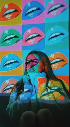 a woman with her hands on her face in front of an image of colorful lips