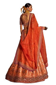 Orange attached cancan lehenga with botanical woven motifs and embroidered border. Paired with dori, aari embroidered padded blouse and dupatta. - Aza Fashions Orange Raw Silk Choli, Fitted Orange Pre-draped Saree For Wedding, Elegant Orange Lehenga For Navratri, Orange Silk Pre-draped Saree For Wedding, Orange Pre-draped Saree With Dupatta For Wedding, Orange Pre-draped Saree For Wedding And Navratri, Orange Lehenga For Festive And Transitional Seasons, Transitional Orange Lehenga With Pallu Detail, Transitional Orange Lehenga With Pallu