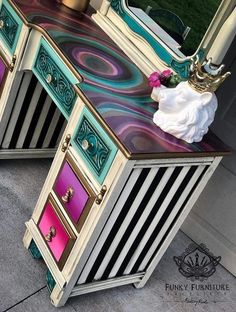 an ornate vanity with colorful drawers and mirror