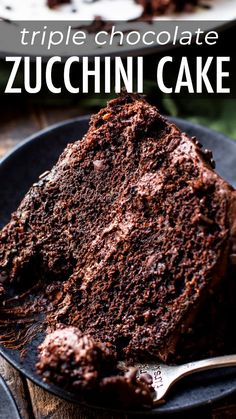 a piece of chocolate zucchini cake on a black plate with a silver fork