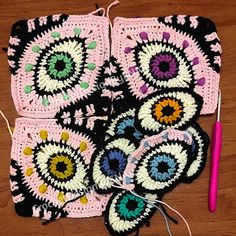 crocheted coasters are sitting on the floor next to a knitting needle