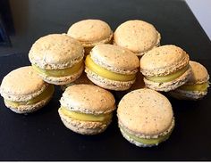 a pile of small sandwiches sitting on top of a black table next to each other