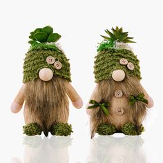 two knitted gnomes with plants on their heads