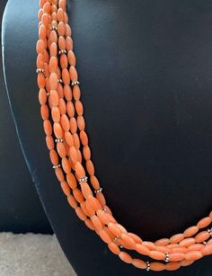 Sterling Silver Multi Strand Pink Coral Bead Necklace. 22 inch Elegant Orange Necklaces With Polished Beads, Elegant Orange Beaded Necklaces With Gemstone Beads, Elegant Orange Gemstone Beaded Necklaces, Elegant Orange Gemstone Beads Necklace, Elegant Orange Hand-strung Necklace, Elegant Rondelle Beaded Necklaces With Large Beads, Elegant Orange Polished Beads Jewelry, Elegant Orange Jewelry With Polished Beads, Orange Oval Beaded Jewelry With Polished Finish