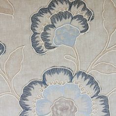 an upholstered fabric with blue flowers on it