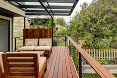 a wooden deck with two couches on it