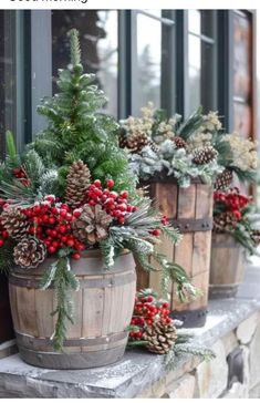 christmas decorations in wooden buckets sitting on a window sill with pine cones and berries