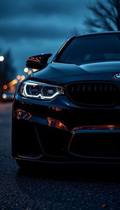 the front end of a black bmw car