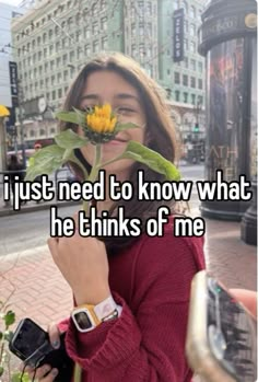 a woman holding up a flower with the words i just need to know what he thinks of