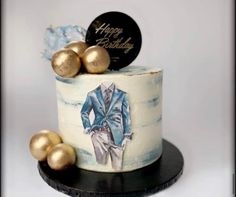 a birthday cake decorated with an image of a man's suit and gold balls