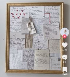 a collage of handwritten letters and magnets is displayed in a gold frame