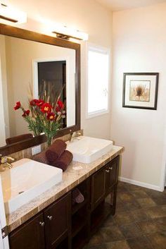 a bathroom with two sinks and a large mirror