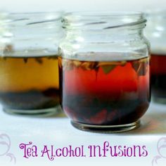 three jars filled with liquid sitting on top of a table