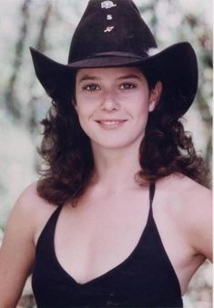 a woman wearing a cowboy hat posing for a photo