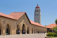 an old building with arches and a clock tower in the background