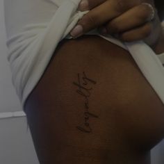 the back of a woman's stomach with her name written in cursive writing