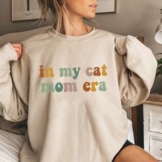 In My Cat Mom Era Shirt, Cat Mom Shirt, Cat Mom Life Shirt, Cat Mom Vibes Shirt, Cat Lover Shirt, Fur Mama Shirt, Gift For Cat Mom, Cat Tee 📢Please Check All Photos For Details.   📢Choose Your T-Shirt Size From The Drop-Down Lists Next To The item Picture   📢Choose Of Your T-Shirt Color From The 2nd Picture 🧨Please contact the store for long-sleeved shirt and sweatshirt color options. 🧨Please check which product you are paying for in the size options section, because there are different opt Cat Mom Outfits, Gifts For Cat Owners, Fur Mama Shirt, Mom Vibes, Cat Mom Shirt, Cat Mom Shirts, Mom Cat, Mom Era, Fur Mama