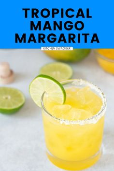 a close up of a margarita in a glass with limes around it and the text tropical mango margarita