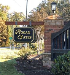 the sign for bogan gates is posted in front of a brick building and gate